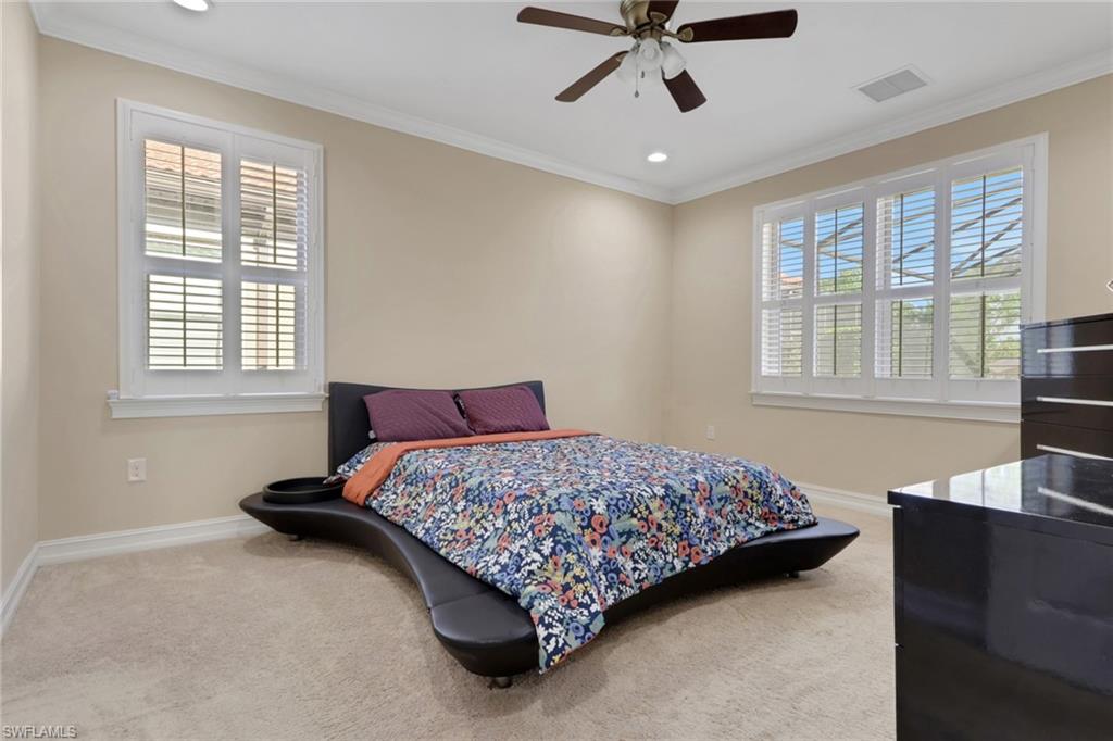 16309 Aberdeen Way Naples, FL 34110 - Photo 14 of 34 a bedroom with a bed and wooden floor