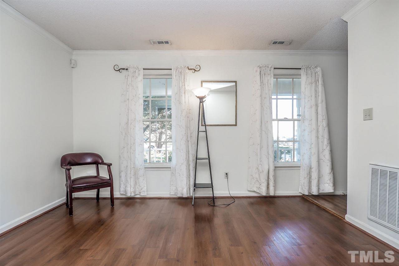 2309 Carthage Circle Raleigh, NC 27604 - Photo 4 of 23 an empty room with wooden floor and windows