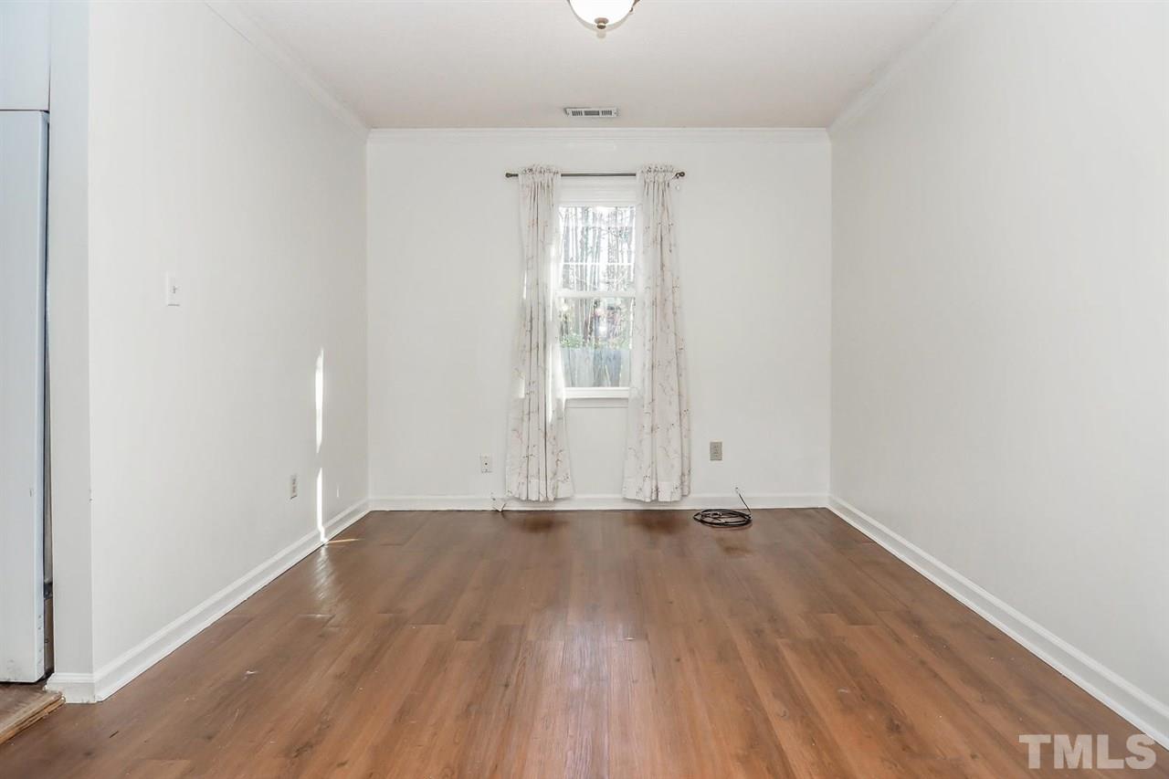 2309 Carthage Circle Raleigh, NC 27604 - Photo 6 of 23 an empty room with wooden floor and windows