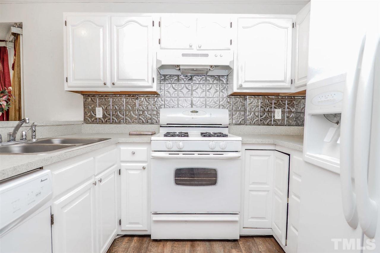 2309 Carthage Circle Raleigh, NC 27604 - Photo 8 of 23 a white stove top oven sitting inside of a kitchen