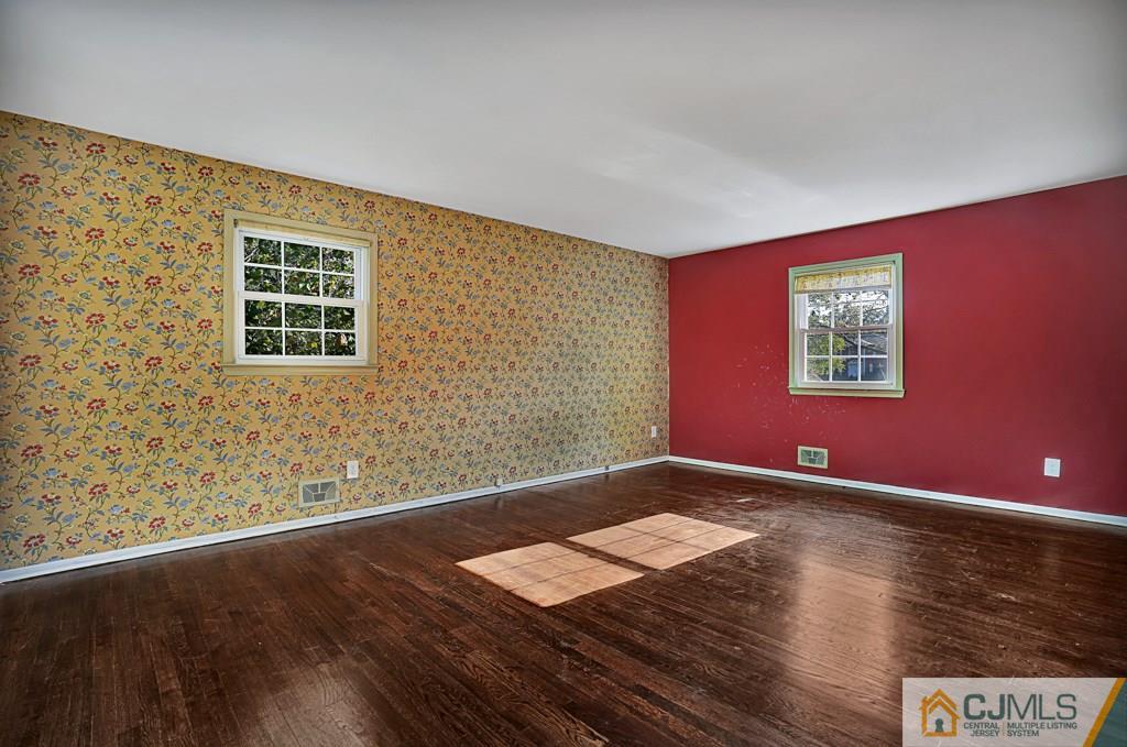1081 Raritan Road Scotch Plains, NJ 07076 - Photo 12 of 27 a view of an empty room with wooden floor and a window