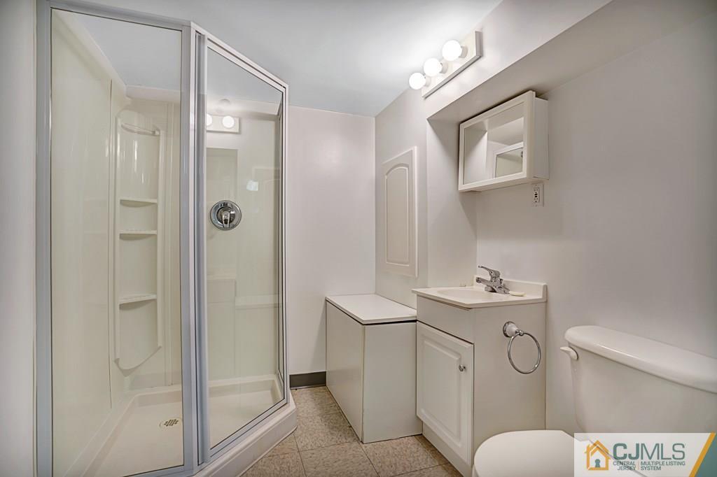 1081 Raritan Road Scotch Plains, NJ 07076 - Photo 21 of 27 a bathroom with a toilet sink and shower