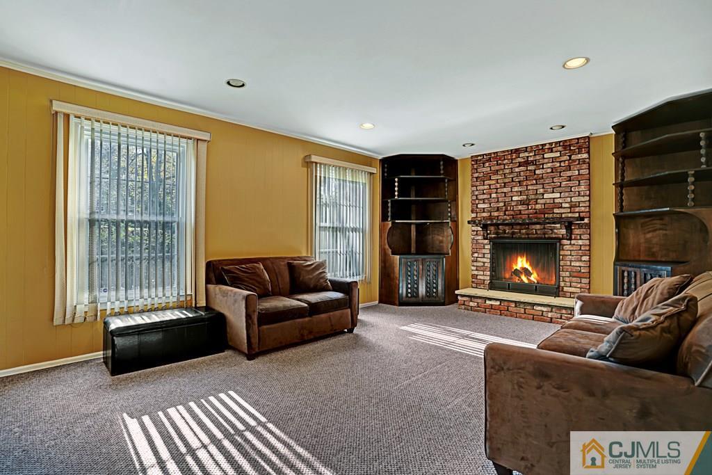 1081 Raritan Road Scotch Plains, NJ 07076 - Photo 5 of 27 a living room with furniture and a fireplace