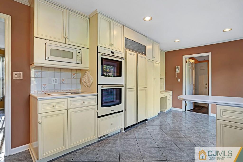 1081 Raritan Road Scotch Plains, NJ 07076 - Photo 8 of 27 a kitchen with stainless steel appliances granite countertop a refrigerator and a stove top oven