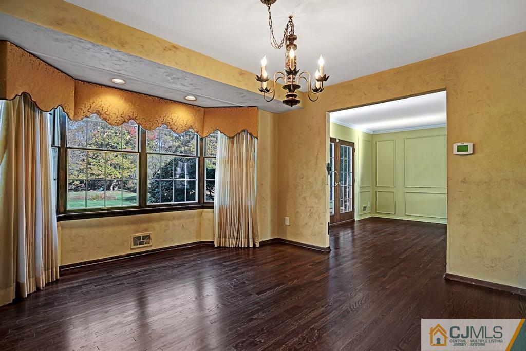 1081 Raritan Road Scotch Plains, NJ 07076 - Photo 9 of 27 a view of an empty room with wooden floor and a window