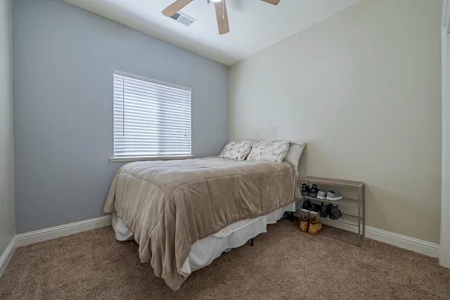 a bed sitting in a bedroom next to a window