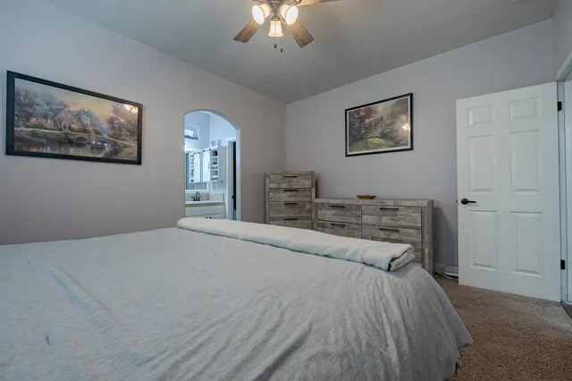 a bedroom with a bed and a chandelier