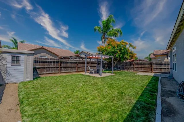 a view of backyard with seating area and green space