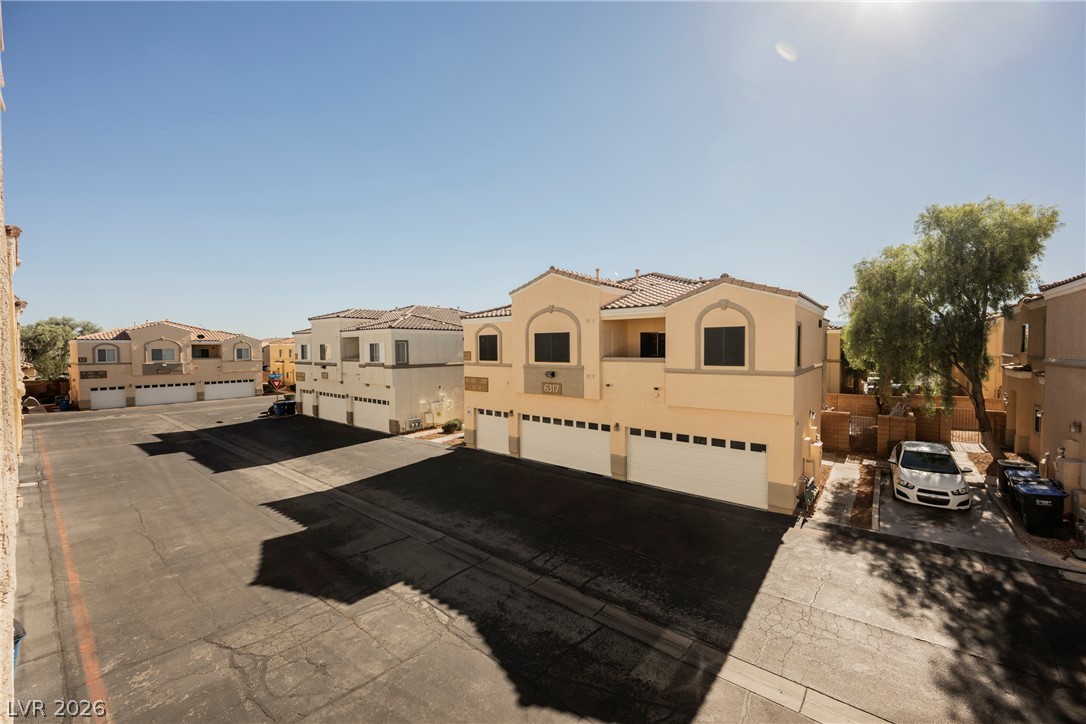 6320 Snap Ridge Street, Unit 201 North Las Vegas, NV 89081 - Photo 53 of 56 Multi-story desert homes with individual garages and ample parking define this community.