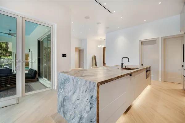 a kitchen with a table chairs stove and cabinets