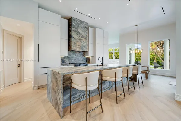 a large kitchen with lots of counter space and glass windows