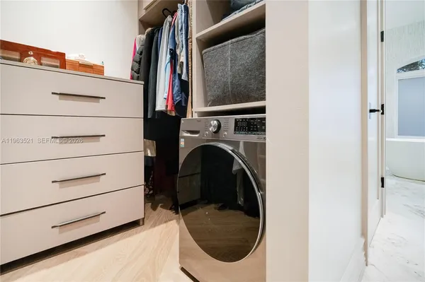a view of a workspace with furniture and a wooden floor
