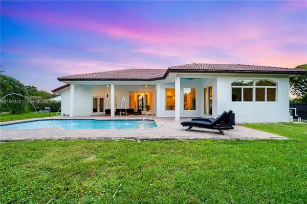an aerial view of a house with a garden and swimming pool