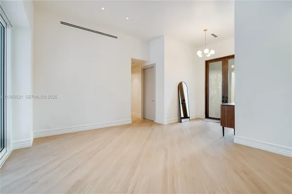 an empty room with furniture and window