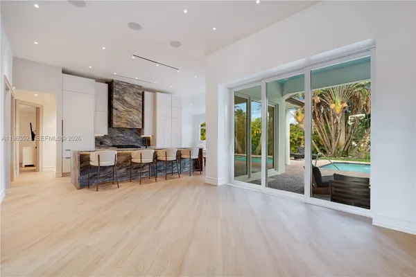 a kitchen with a table chairs sink and cabinets