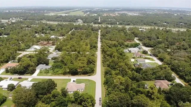 an aerial view of residential house with swimming pool and outdoor space