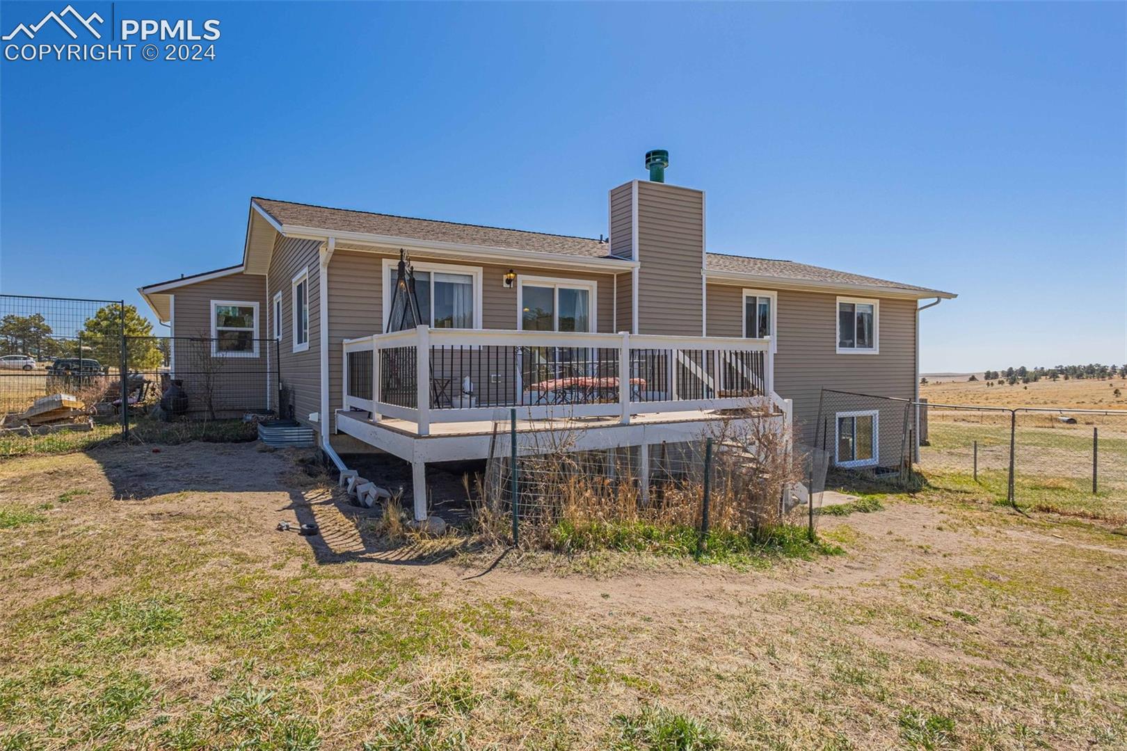 17650 Fremont Fort Road Peyton, CO 80831 - Photo 30 of 41 Back of house with a yard and a deck
