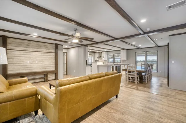 a kitchen with stainless steel appliances granite countertop a sink a stove and a refrigerator