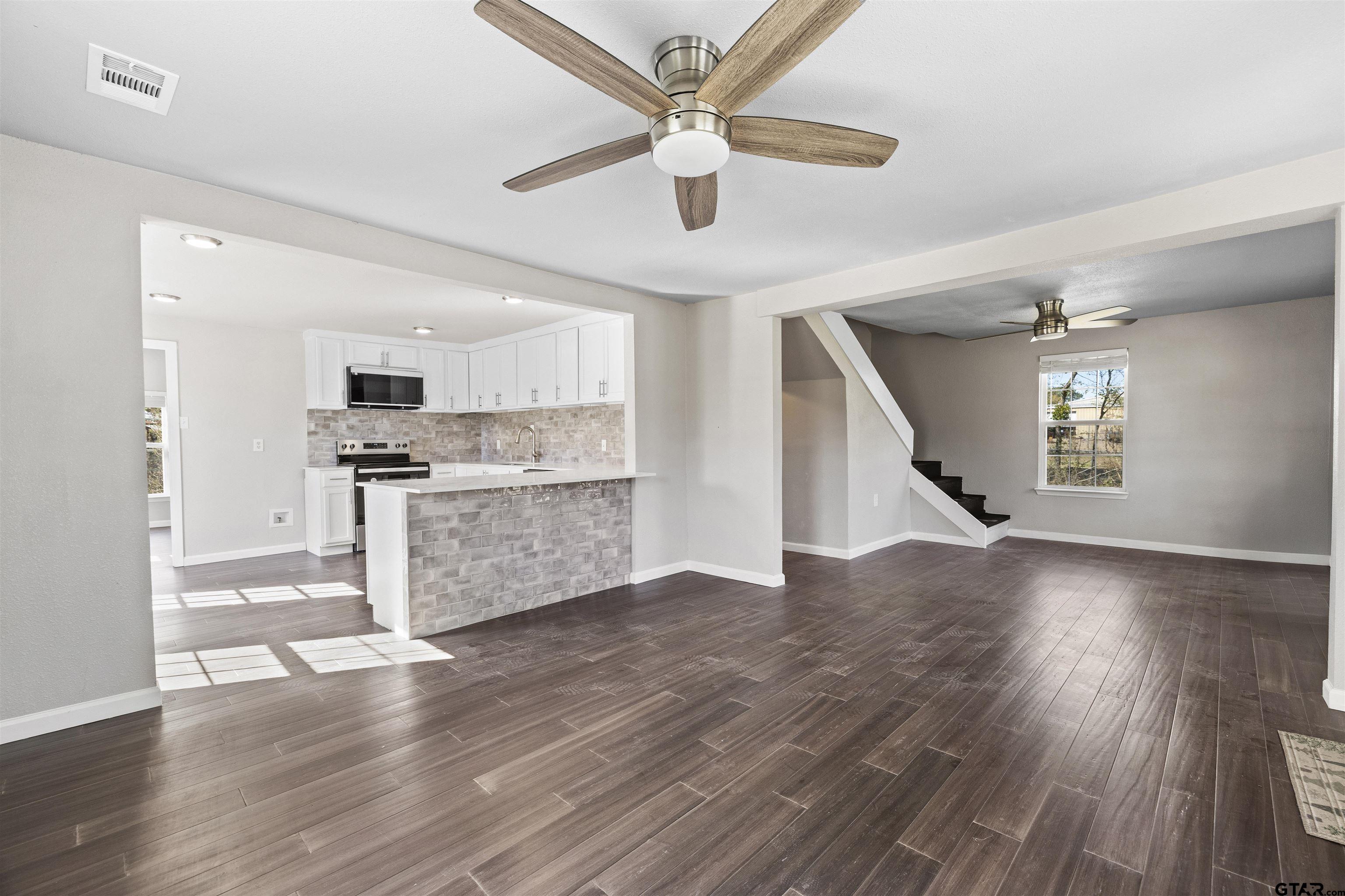 229 Orchard Street Alba, TX 75410 - Photo 5 of 16 a view of kitchen with cabinets and wooden floor