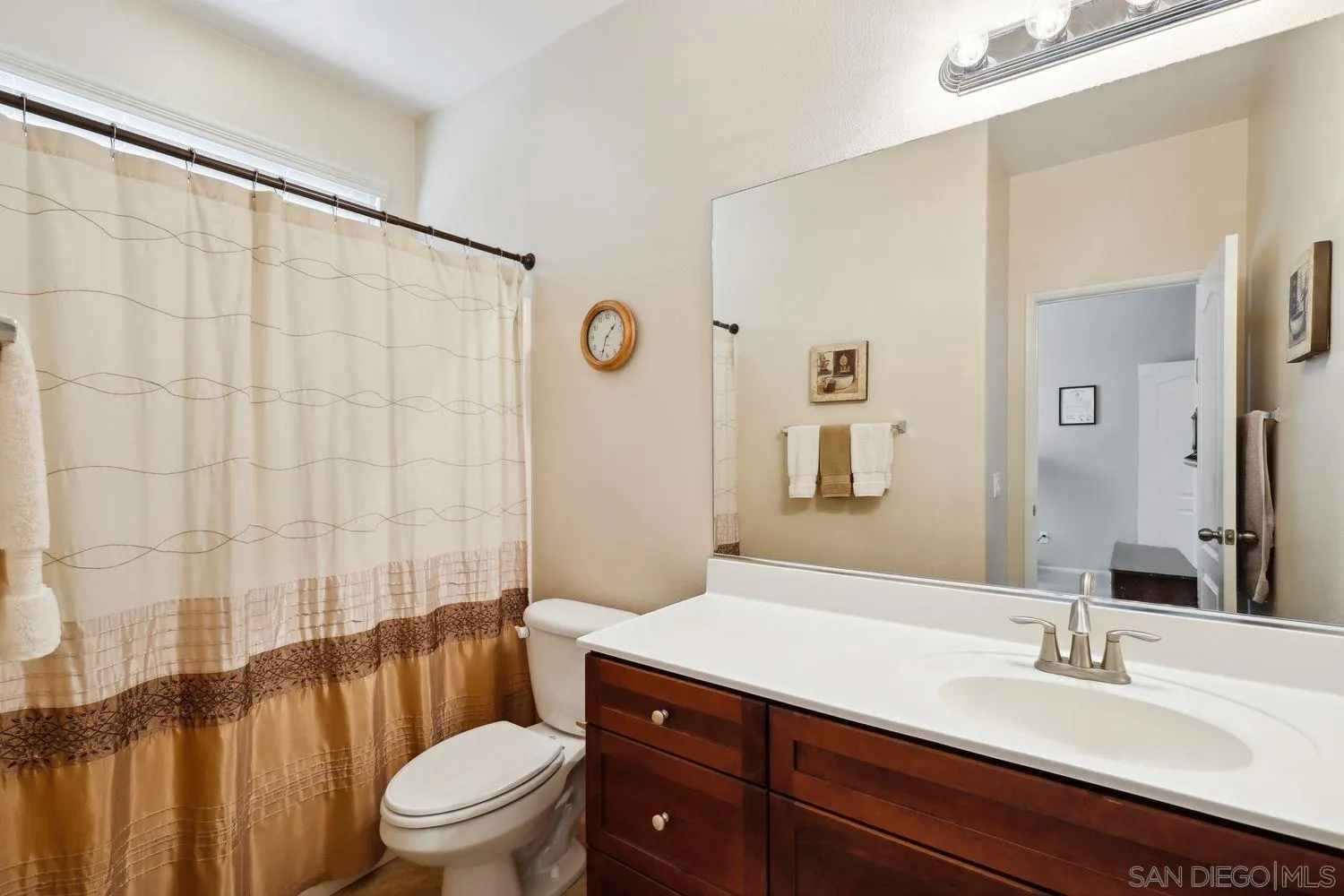3250 Beven Drive Escondido, CA 92027 - Photo 20 of 34 a bathroom with a sink a toilet a mirror a vanity and shower