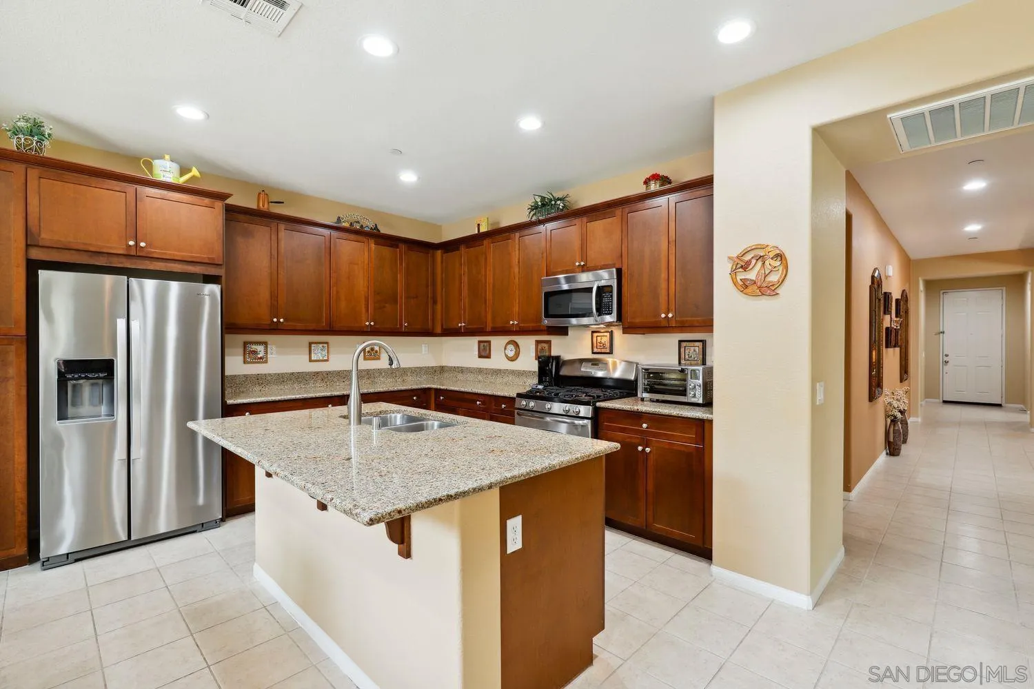 3250 Beven Drive Escondido, CA 92027 - Photo 8 of 34 a kitchen with stainless steel appliances granite countertop a refrigerator stove microwave and sink