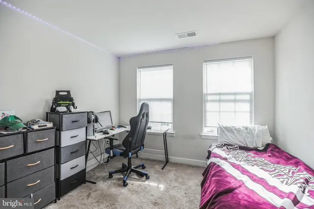 a view of a workspace with a window and lounge chair