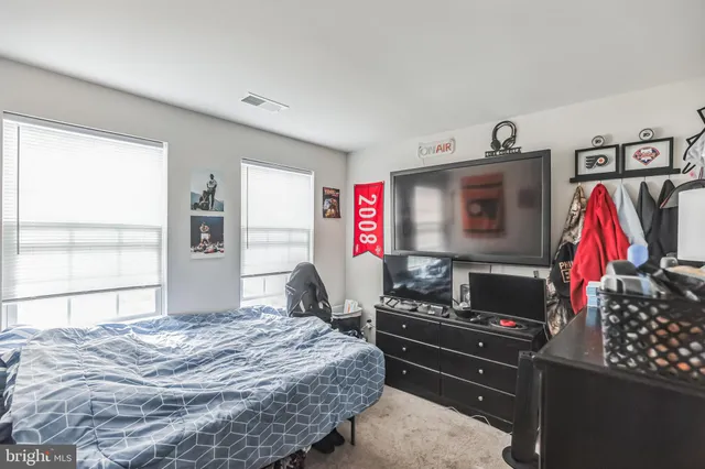 a bedroom with a bed and dresser