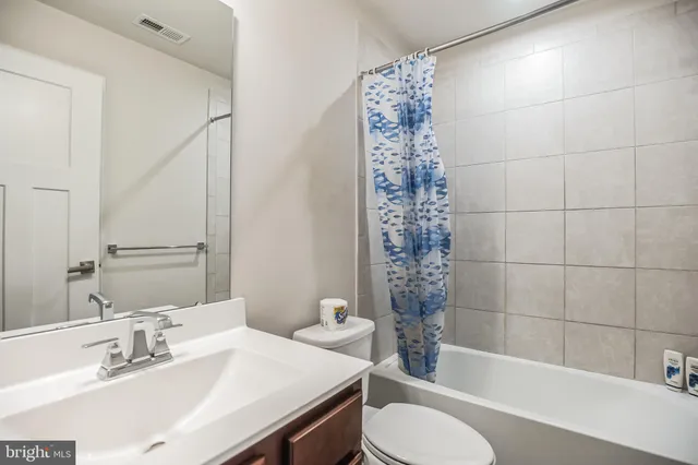 a bathroom with a sink toilet a mirror and shower