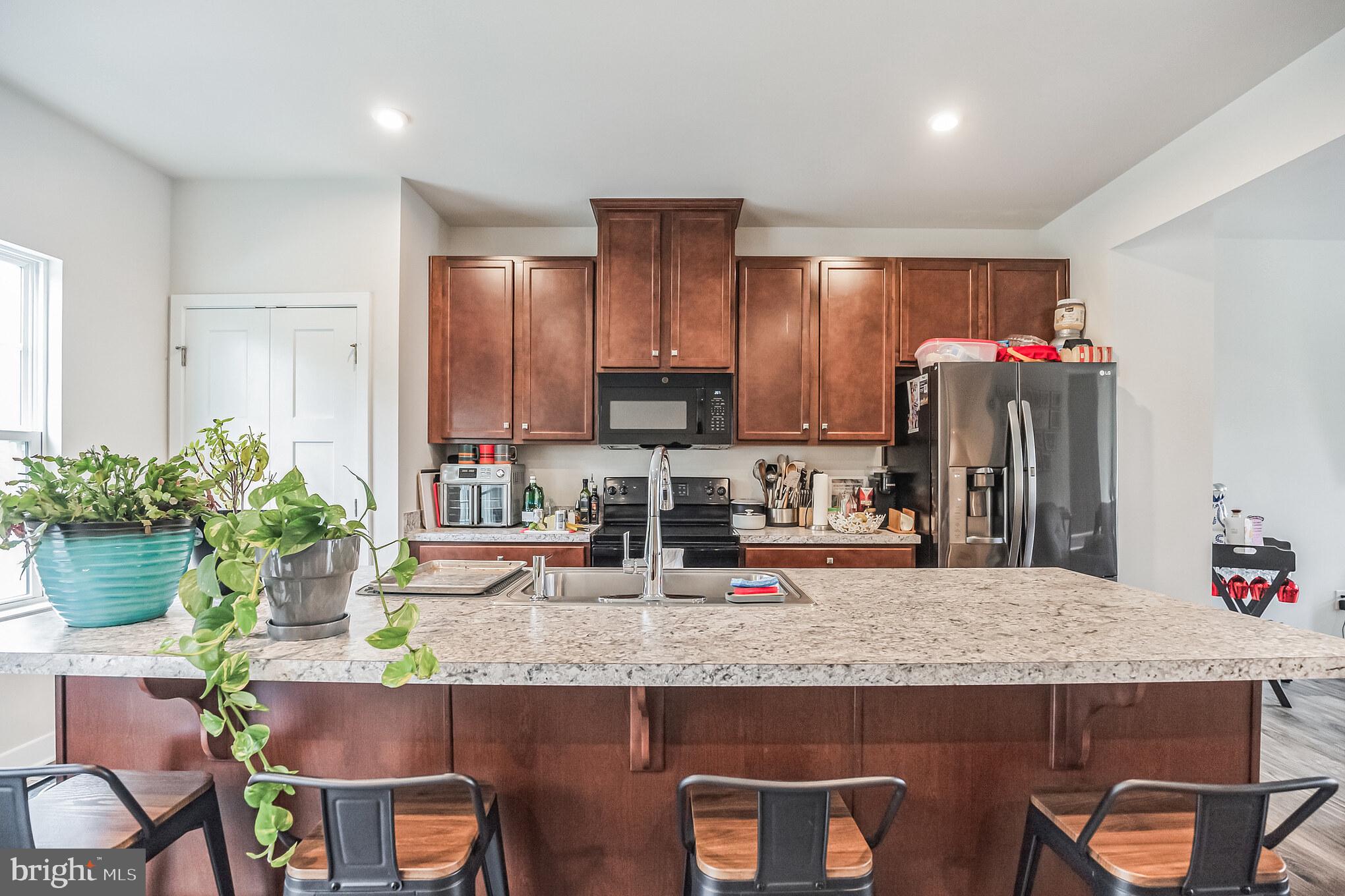 28 Sparrow Circle Sewell, NJ 08080 - Photo 6 of 15 a kitchen with granite countertop kitchen island stainless steel appliances a sink stove and cabinets