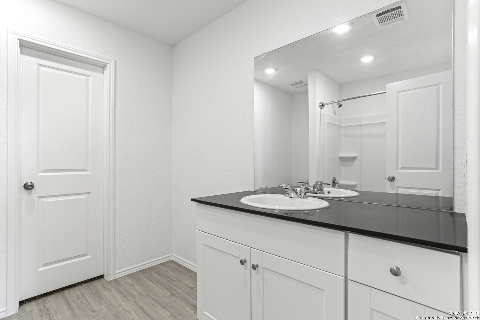 31838 Cherry Bulverde, TX 78163 - Photo 16 of 19 a bathroom with a granite countertop sink and a mirror