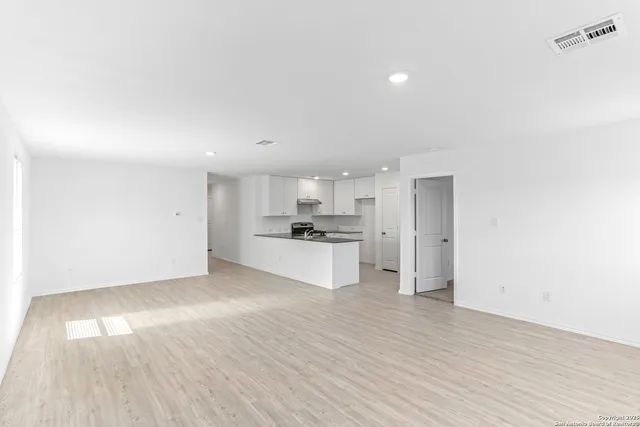 a view of kitchen view wooden floor and electronic appliances