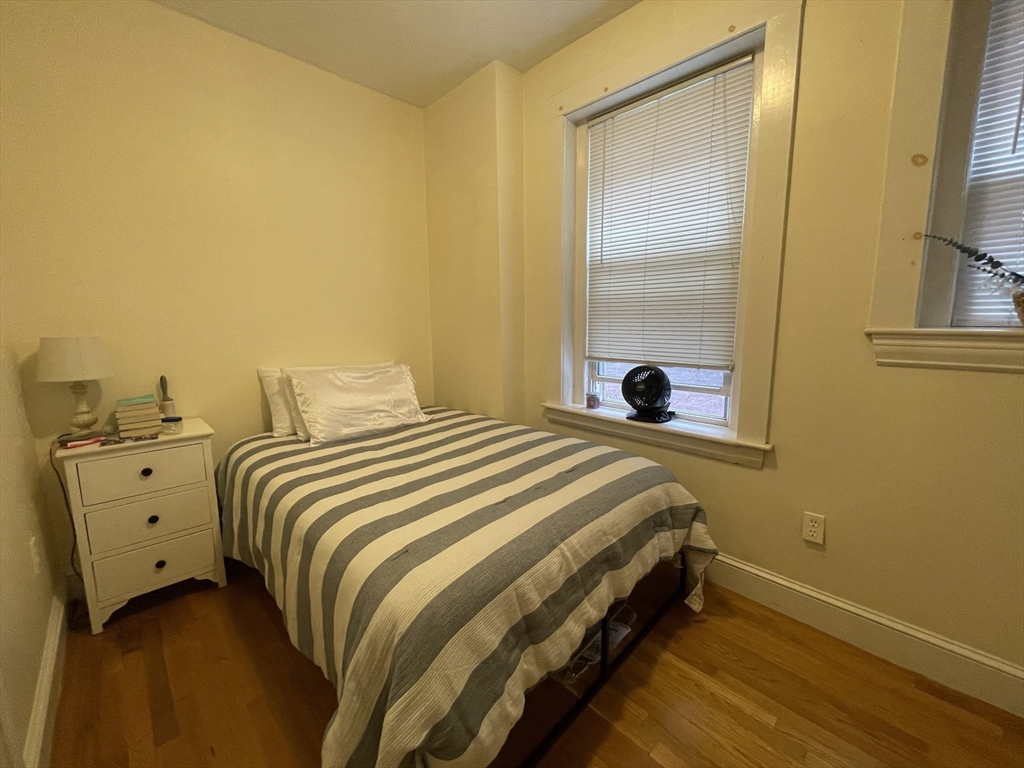 191 Winthrop Road, Unit 2 Brookline, MA 02445 - Photo 12 of 15 a bedroom with a bed and a large mirror