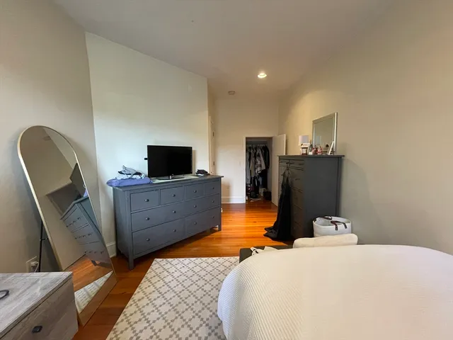 a bedroom with a bed and flat screen tv