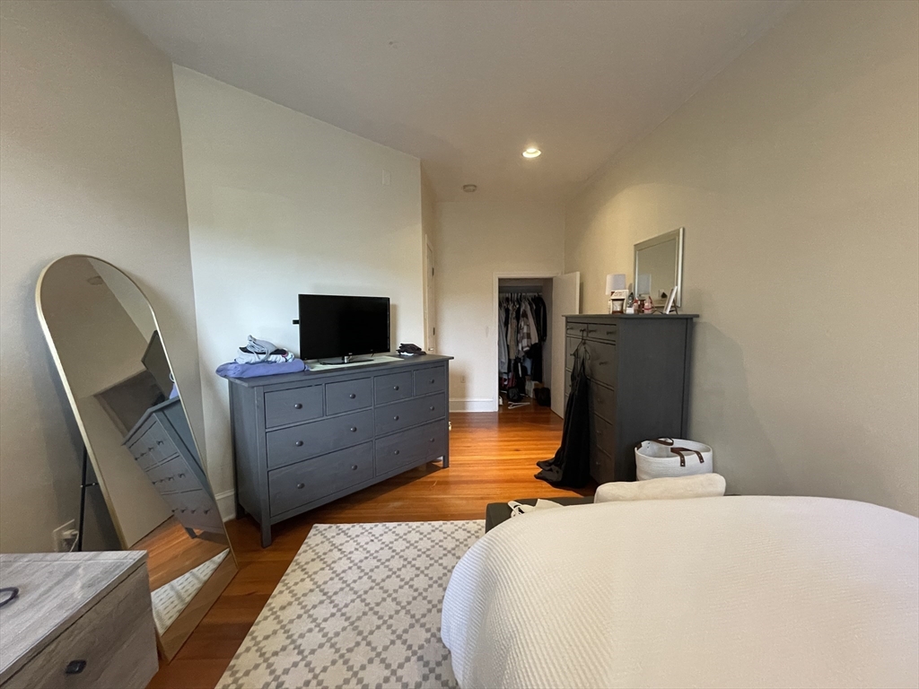 191 Winthrop Road, Unit 2 Brookline, MA 02445 - Photo 2 of 15 a bedroom with a bed and flat screen tv