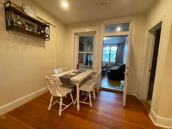 a view of a dining room with furniture and wooden floor