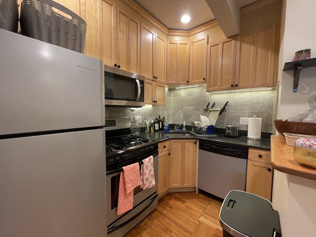 191 Winthrop Road, Unit 2 Brookline, MA 02445 - Photo 6 of 15 a kitchen with stainless steel appliances a refrigerator stove top oven and sink