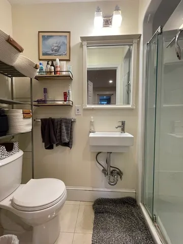 a bathroom with a toilet a sink and mirror