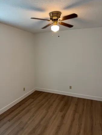 a view of a room with wooden floor