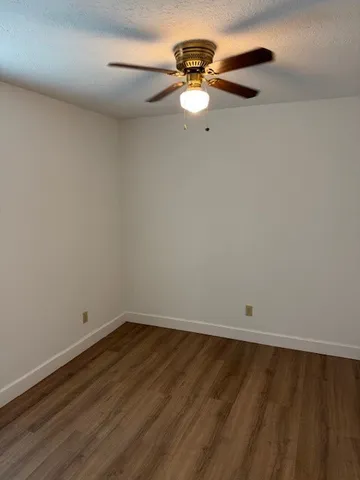 a view of a room with wooden floor