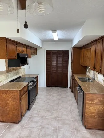 a kitchen with stainless steel appliances granite countertop a stove and a sink