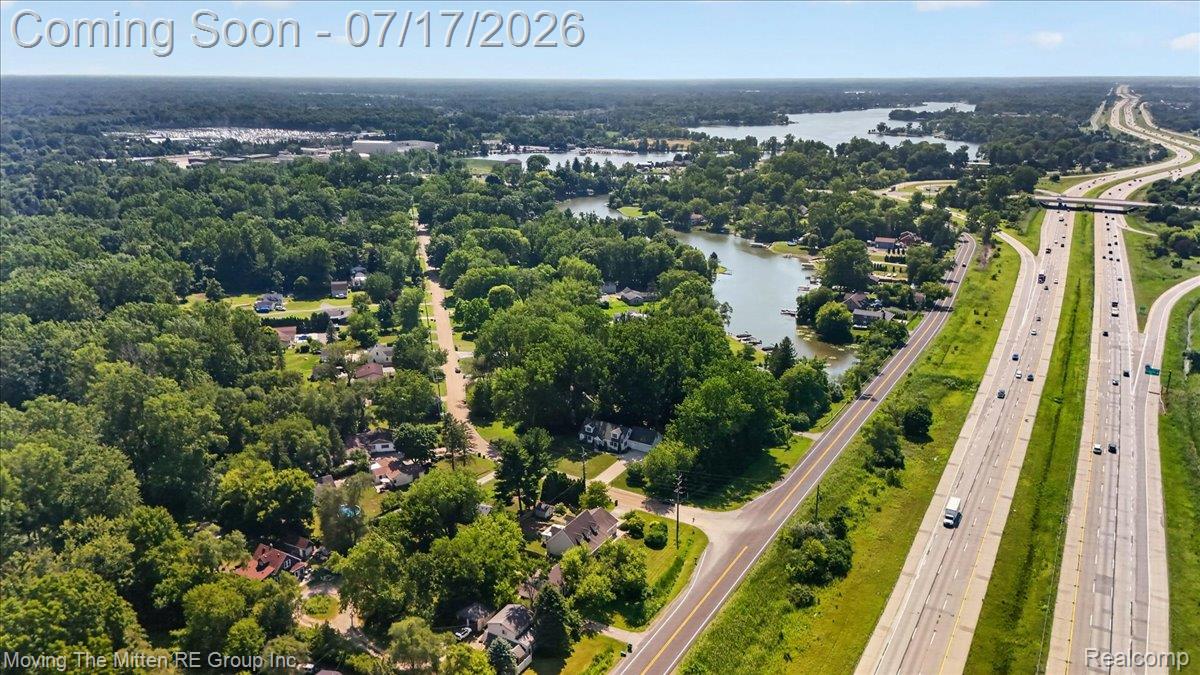 40162 Alden Road Belleville, MI 48111 - Photo 66 of 67 Aerial perspective showcasing a residential area bordered by a highway and a body of water