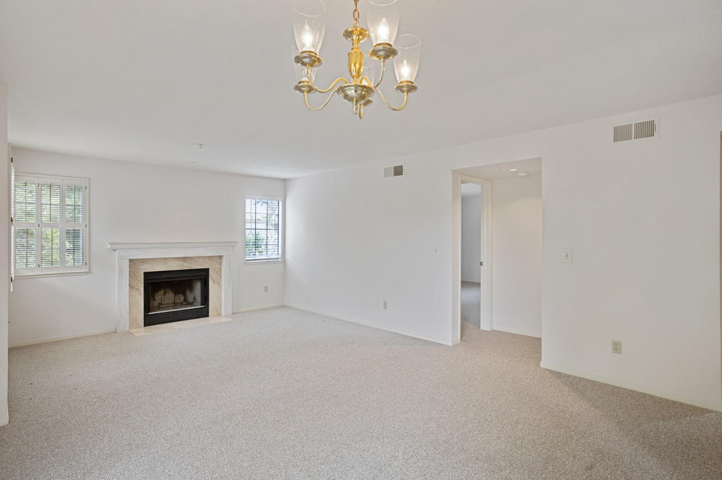 130 Pheasant Ridge Road Del Rey Oaks, CA 93940 - Photo 8 of 23 a view of a livingroom with a fireplace a chandelier and windows
