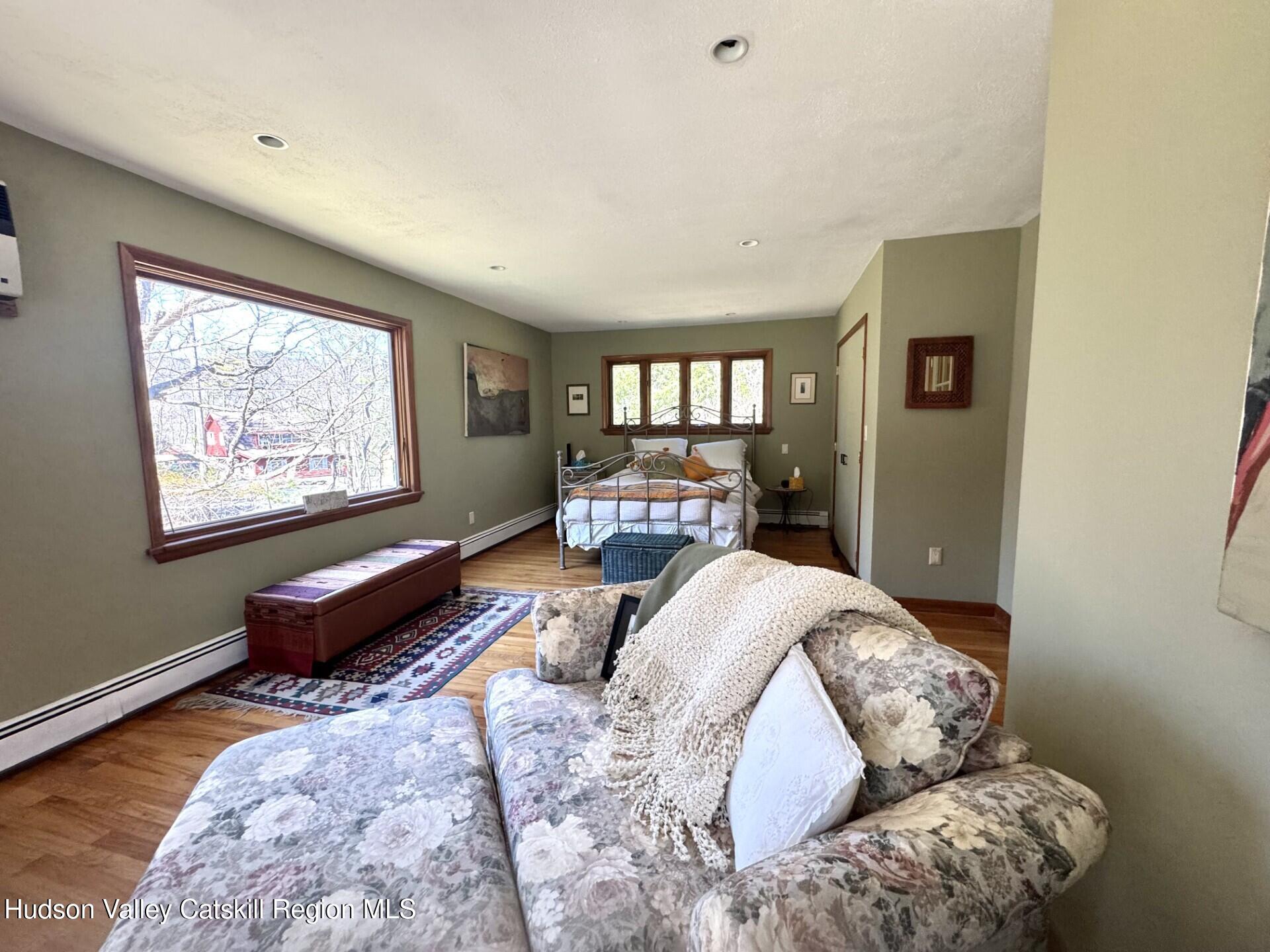 115 Jones Quarry Road Woodstock, NY 12498 - Photo 18 of 38 a bedroom with furniture and a large window