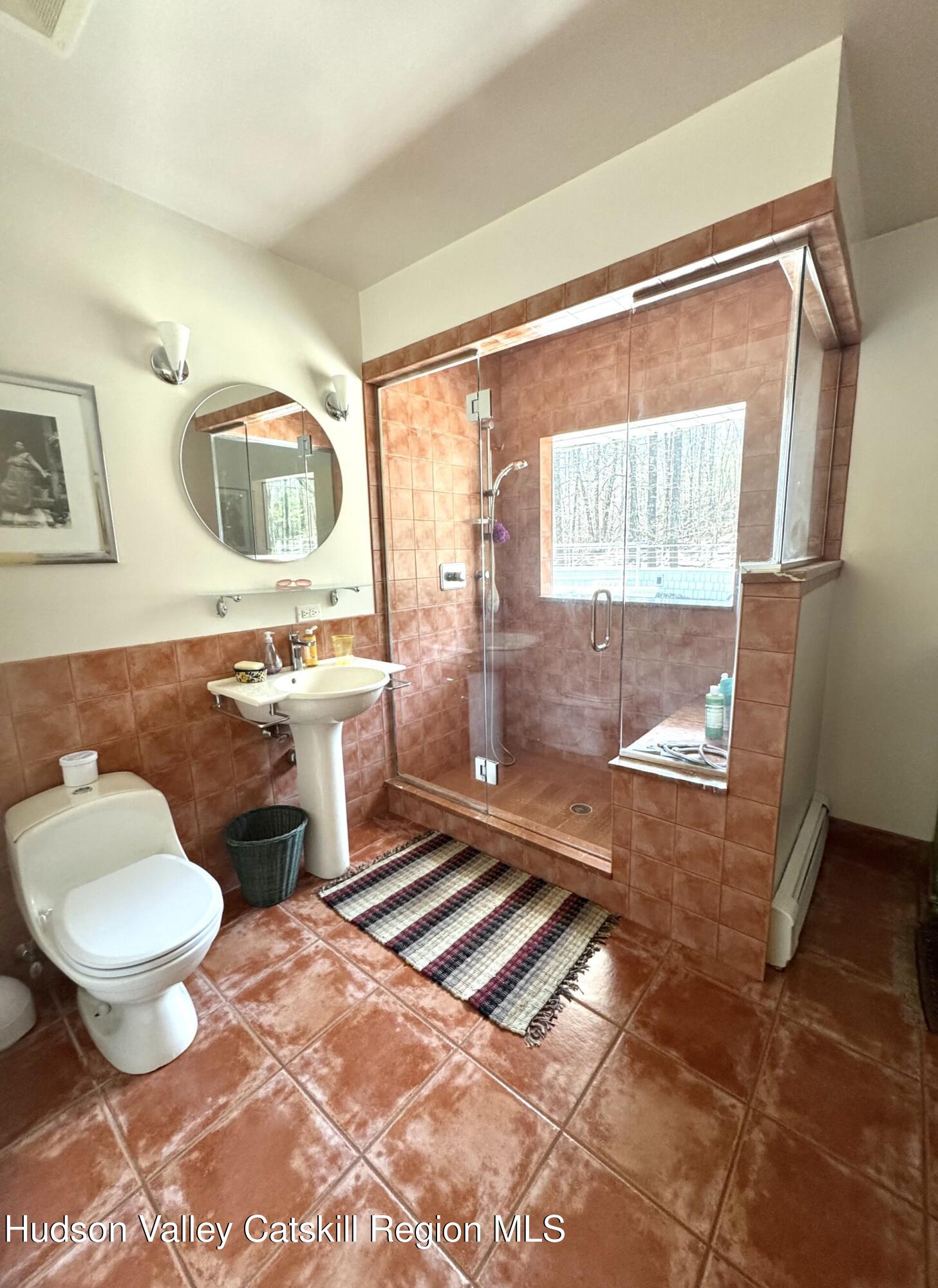 115 Jones Quarry Road Woodstock, NY 12498 - Photo 26 of 38 a bathroom with a sink toilet and shower