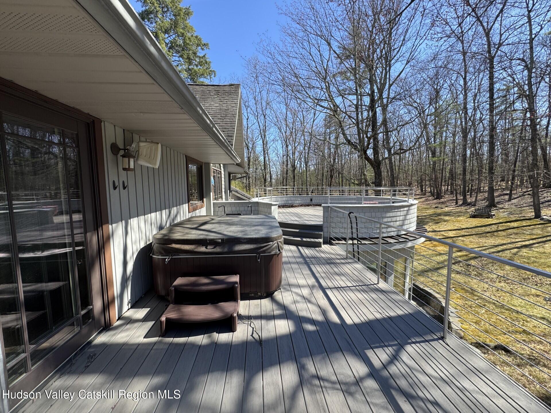 115 Jones Quarry Road Woodstock, NY 12498 - Photo 32 of 38 a view of a patio with table and chairs and wooden floor