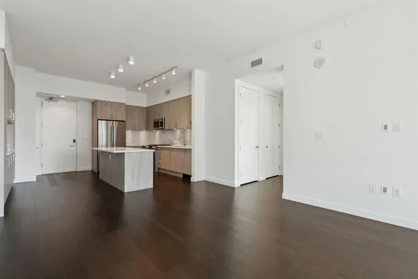 a view of a kitchen with wooden floor and a sink