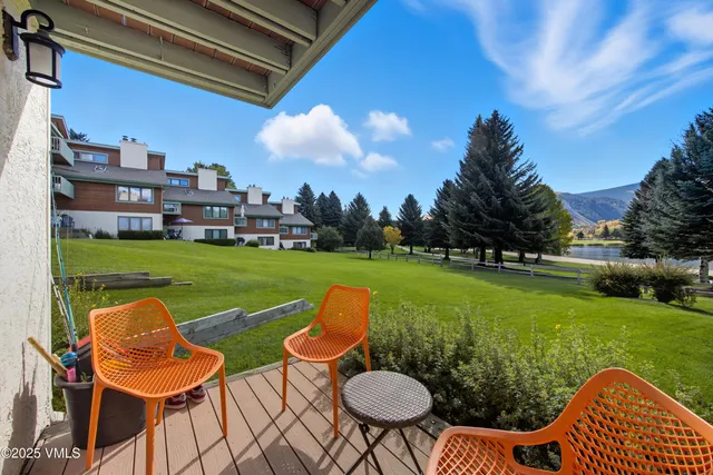 a view of a chair and table in the garden