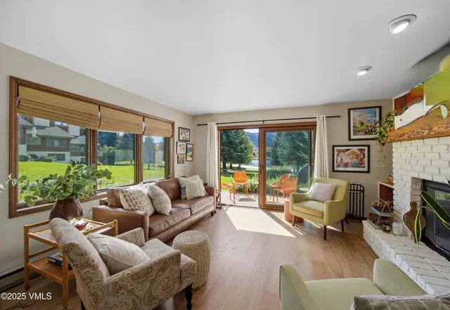 a living room with furniture large windows and a flat screen tv