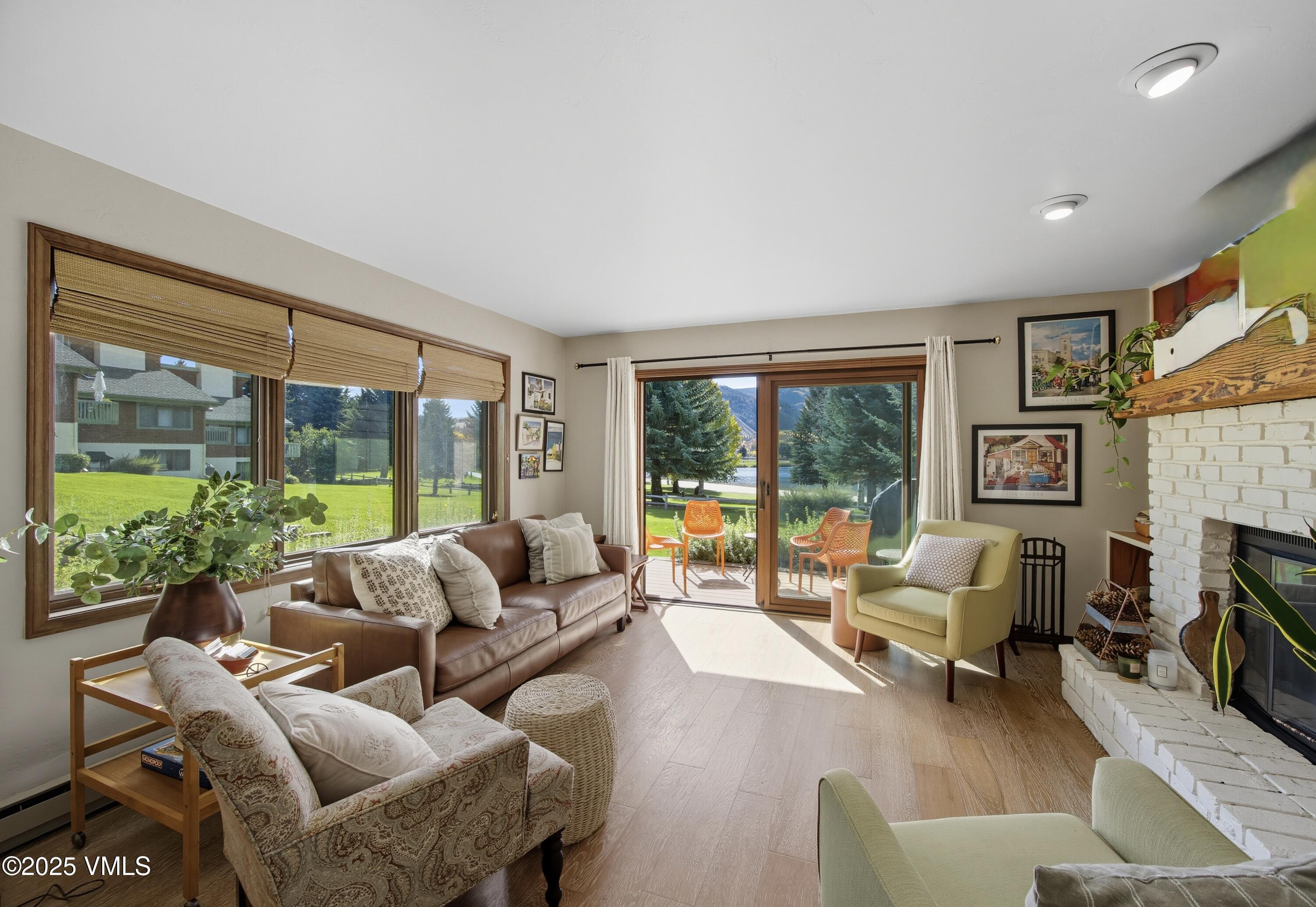 520 West Beaver Creek Boulevard, Unit A103 Avon, CO 81620 - Photo 2 of 21 a living room with furniture large windows and a flat screen tv