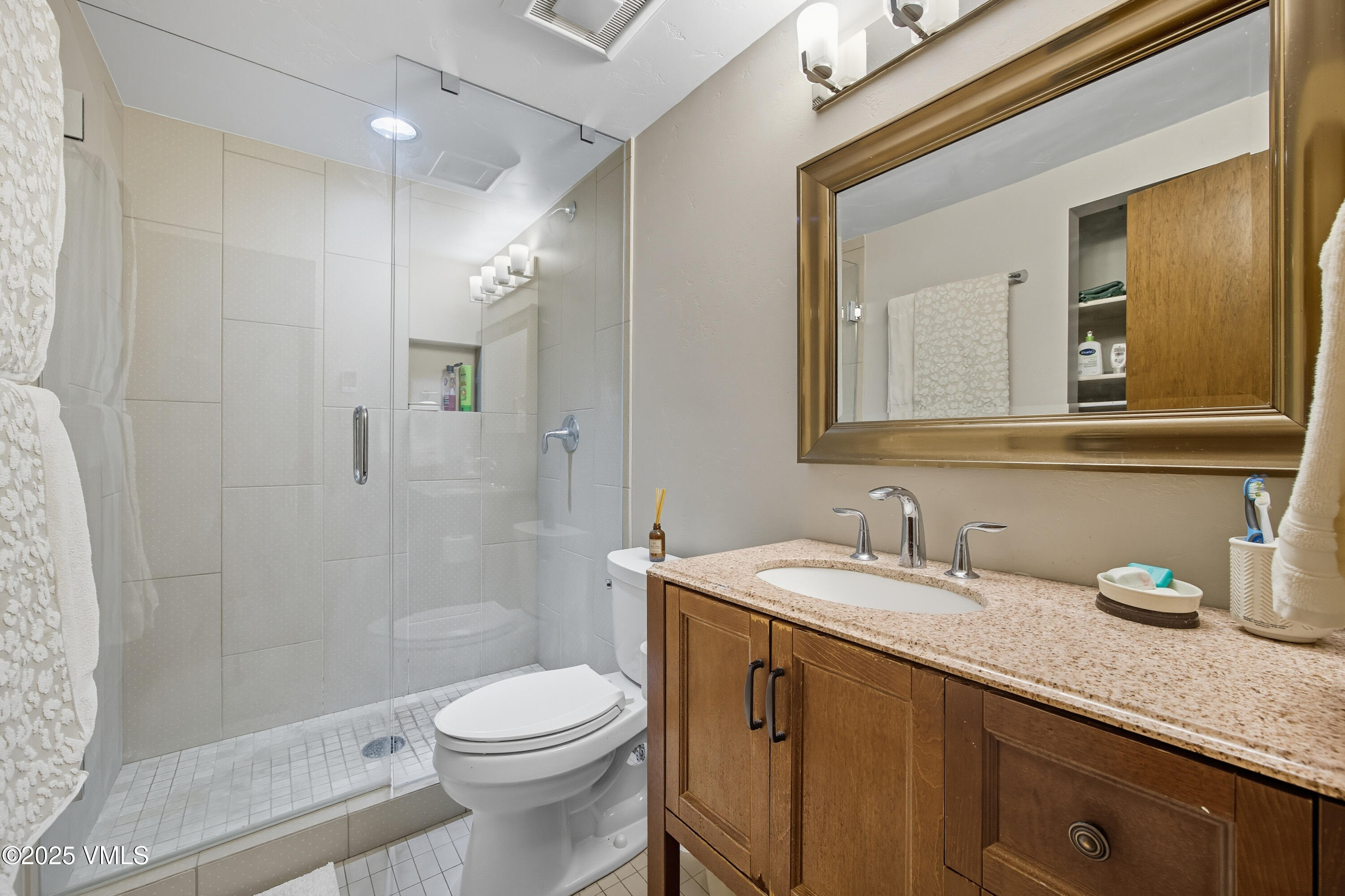 520 West Beaver Creek Boulevard, Unit A103 Avon, CO 81620 - Photo 9 of 21 a bathroom with a granite countertop sink toilet and shower